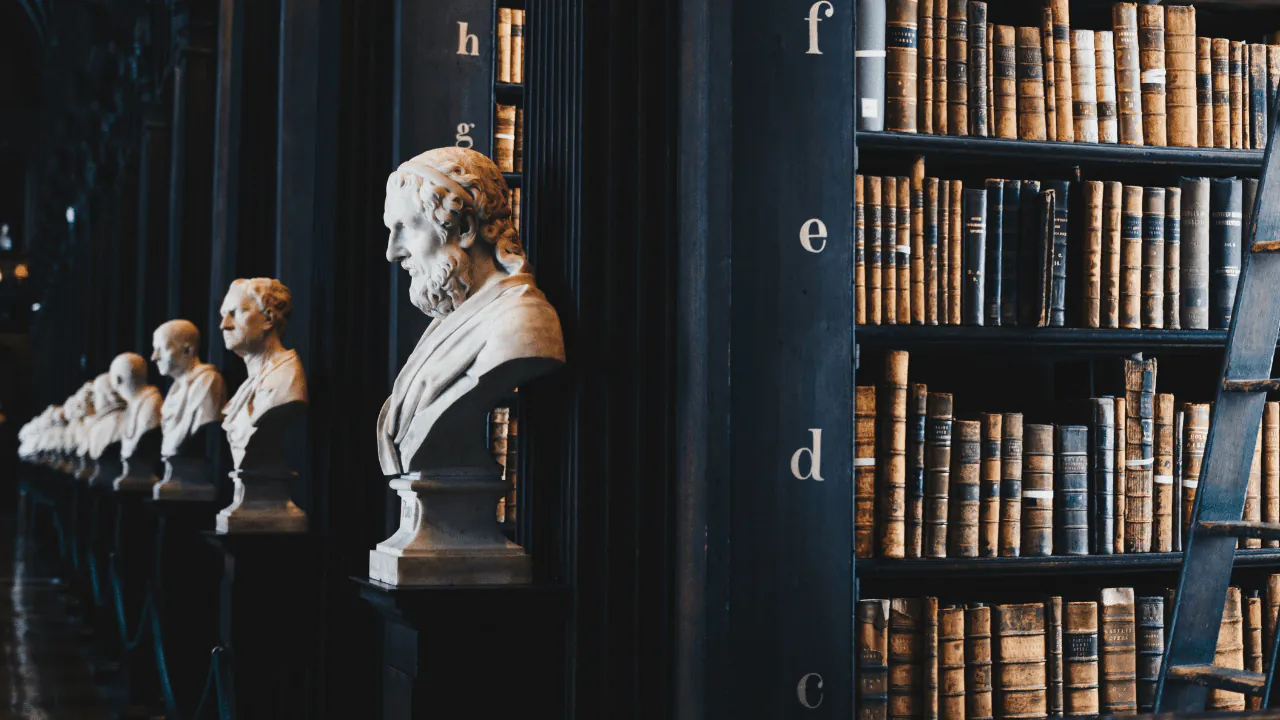 Legal English training: a historic library lined with marble busts and leather-bound books